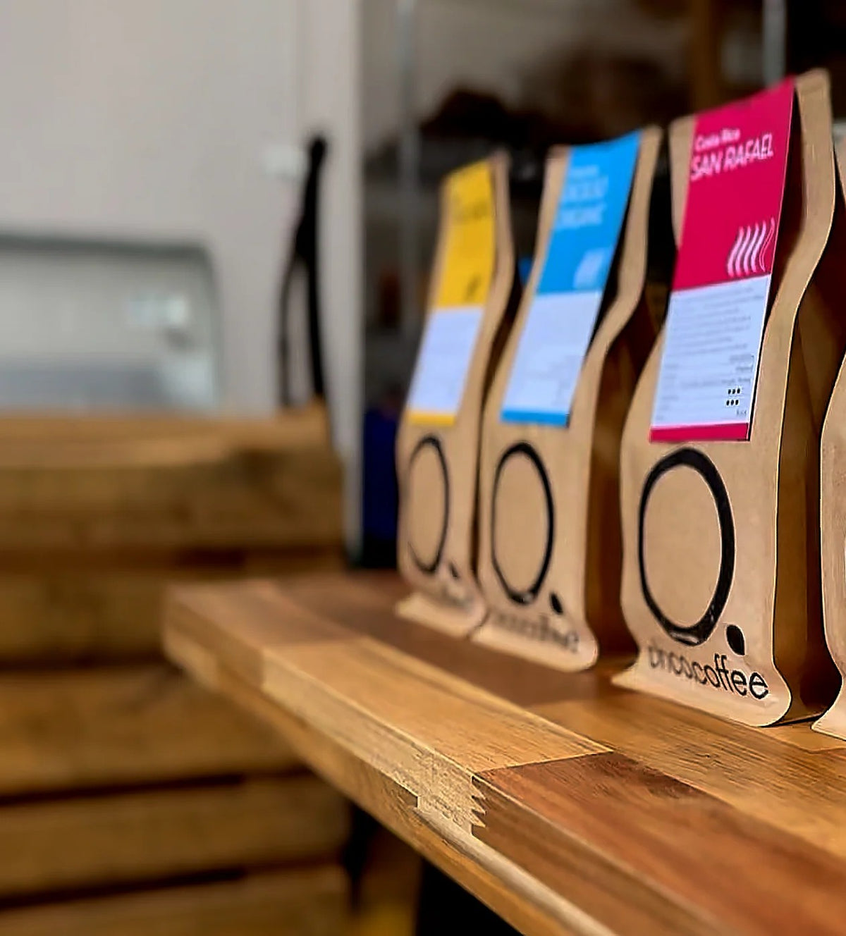 OHCO Coffee bags of Ethiopia, Colombia Excelso and Costa Rica San Rafael on a wooden bench at the Hursley roastery